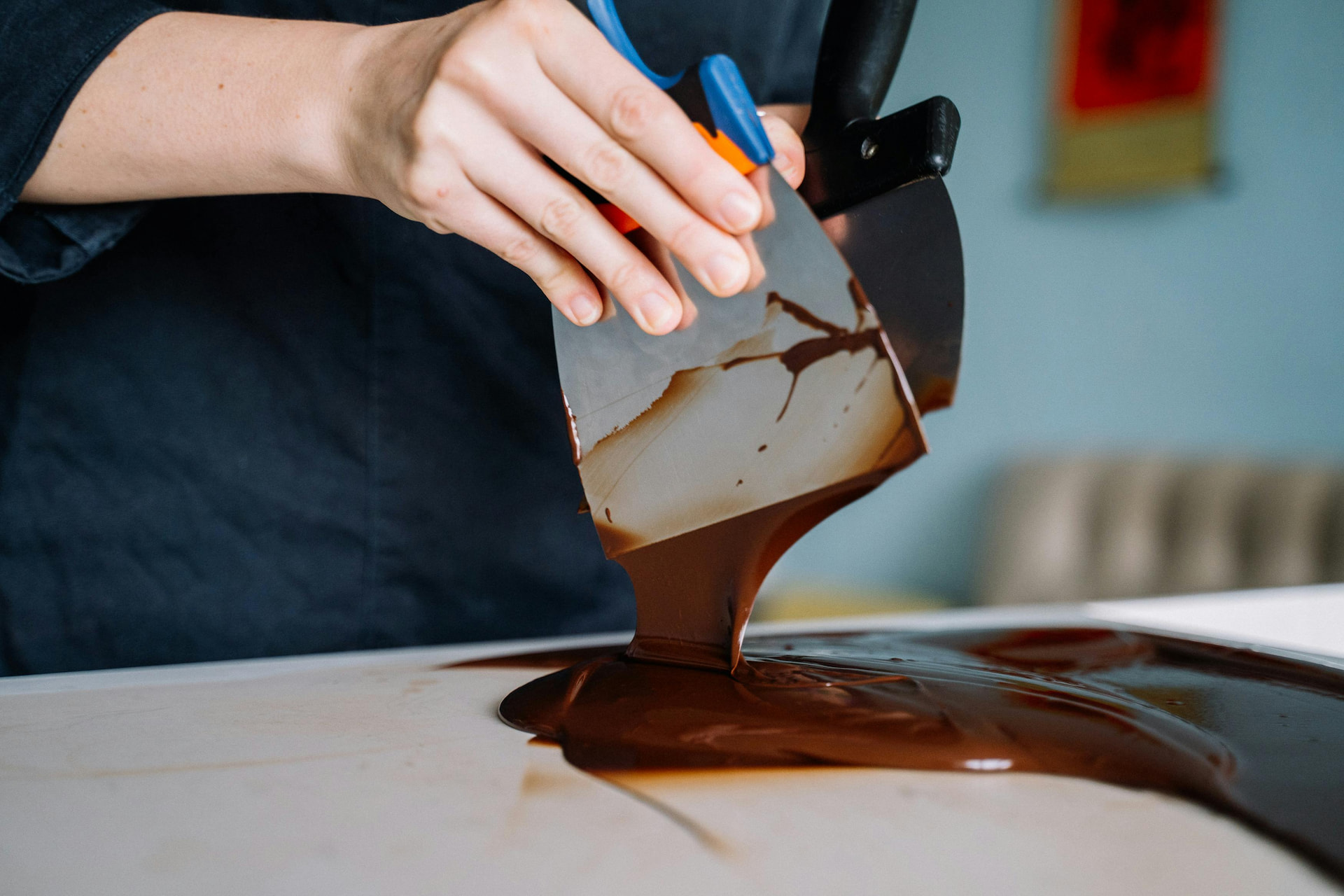 A pastry chef tempering chocolate.