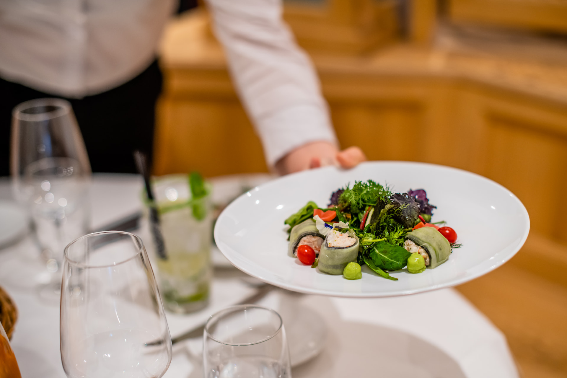 A waiter serving food.