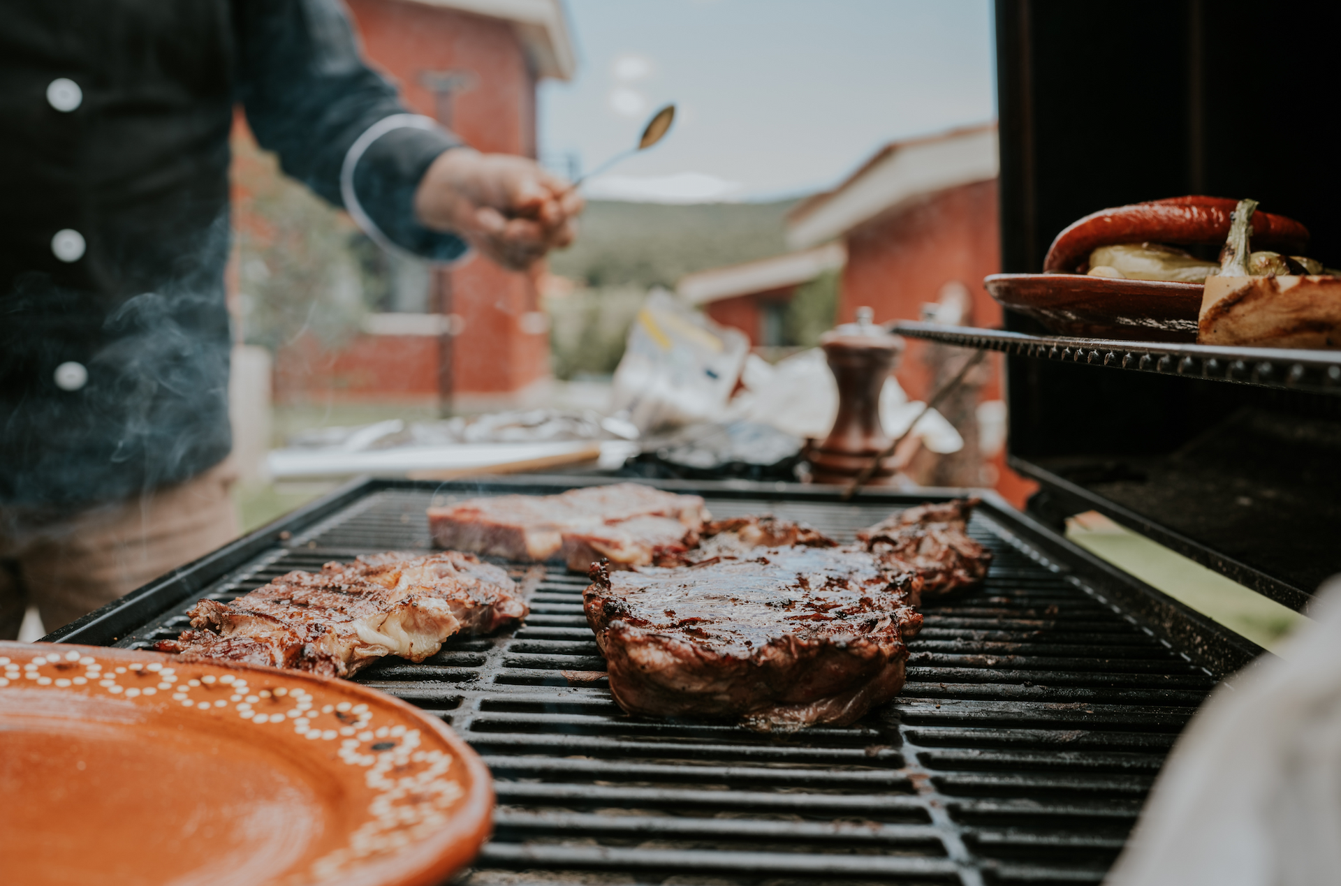 A chef grilling meat